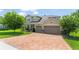 Beautiful two-story home with a brick driveway and three-car garage, offering ample space and curb appeal at 2401 Oxmoor Dr, Deland, FL 32724