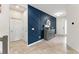 Welcoming foyer with blue accent wall, stylish console, and access to the staircase at 2401 Oxmoor Dr, Deland, FL 32724