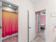 Hallway view to a bathroom and a bedroom with neutral tones and tile flooring at 2401 Oxmoor Dr, Deland, FL 32724