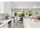 Bright kitchen featuring white cabinets, a quartz countertop island, and stainless steel appliances at 2401 Oxmoor Dr, Deland, FL 32724