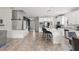 Bright, open kitchen with white cabinets, stainless appliances, and a large center island with seating at 2401 Oxmoor Dr, Deland, FL 32724