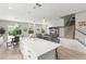 Open-concept kitchen with island and bar seating flows into a living area at 2401 Oxmoor Dr, Deland, FL 32724