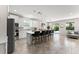 Modern, open-concept kitchen with white cabinetry, a central island, and stainless steel appliances at 2401 Oxmoor Dr, Deland, FL 32724