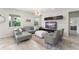 Bright living room with large windows, comfortable seating, and a modern entertainment center at 2401 Oxmoor Dr, Deland, FL 32724
