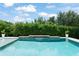 Backyard pool with a waterfall feature and lush landscaping at 2401 Oxmoor Dr, Deland, FL 32724