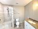 This bathroom offers a tiled walk-in shower with a built-in bench and updated vanity at 2630 S Tanner Rd, Orlando, FL 32820