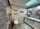 Modern bathroom with stylish gray tiles, glass shower, and double sink vanity at 2630 S Tanner Rd, Orlando, FL 32820