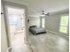 Bright bedroom with modern fan, large windows, and bathroom access at 2630 S Tanner Rd, Orlando, FL 32820
