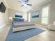 Bright bedroom with blue accents, featuring a ceiling fan and neutral walls at 2630 S Tanner Rd, Orlando, FL 32820