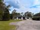 This home features a lengthy driveway and a well kept lawn at 2630 S Tanner Rd, Orlando, FL 32820