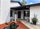 Inviting front entrance with unique water feature, landscaping, and black accents at 2630 S Tanner Rd, Orlando, FL 32820