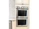 Stainless steel double ovens are set in cabinets with decorative backsplash tiles at 2630 S Tanner Rd, Orlando, FL 32820