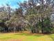 Lush landscaping featuring mature trees with Spanish moss and green lawns at 2630 S Tanner Rd, Orlando, FL 32820