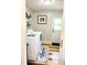 Well-organized laundry room with laundry mat, shelves, and charming decor at 2630 S Tanner Rd, Orlando, FL 32820