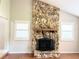 Charming living room with a stone fireplace and natural light through plantation shutters at 2630 S Tanner Rd, Orlando, FL 32820