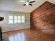 Spacious living room with laminate floors and wood paneled accent wall at 2630 S Tanner Rd, Orlando, FL 32820