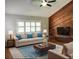Bright living room with blue accents, wood paneled wall, and fireplace at 2630 S Tanner Rd, Orlando, FL 32820