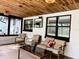 Relax in comfort on this screened patio with a wood plank ceiling and cozy seating at 2630 S Tanner Rd, Orlando, FL 32820