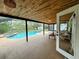 This screened in outdoor pool area is perfect for outdoor dining and entertaining at 2630 S Tanner Rd, Orlando, FL 32820