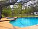 Enjoy a refreshing swim in this screened in outdoor pool and spa at 2630 S Tanner Rd, Orlando, FL 32820