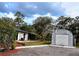 View of the home and matching shed with a metal facade on a spacious lot at 2630 S Tanner Rd, Orlando, FL 32820