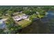 Aerial view of a home on a large lot with lake access and mature trees at 2916 Maldive Ct, Deltona, FL 32738