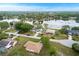Aerial view of neighborhood, with pond and mature landscaping at 2916 Maldive Ct, Deltona, FL 32738