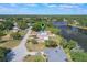 An aerial view of a home in a tree-filled neighborhood on a lake at 2916 Maldive Ct, Deltona, FL 32738