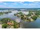 Expansive aerial shot of a lakefront property with lush surroundings and tranquil waters at 2916 Maldive Ct, Deltona, FL 32738