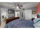 Bedroom featuring a ceiling fan, adjacent bathroom, television, and closet at 2916 Maldive Ct, Deltona, FL 32738