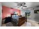Bright bedroom featuring a ceiling fan, window, and unique decor at 2916 Maldive Ct, Deltona, FL 32738