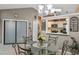 Elegant dining area featuring a glass-top table, view of kitchen, and tile flooring at 2916 Maldive Ct, Deltona, FL 32738
