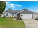Charming single-story home with attached garage, inviting front yard, and well-maintained landscaping at 2916 Maldive Ct, Deltona, FL 32738