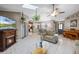 Open-concept living space showcasing fireplace, tile flooring, and view into dining area at 2916 Maldive Ct, Deltona, FL 32738
