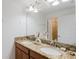 Elegant bathroom with a double vanity, granite countertops, and stylish decor accents at 2923 Banana Palm Dr, Kissimmee, FL 34747