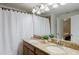 Bright bathroom with double vanity featuring granite countertops, ample lighting, and neutral decor at 2923 Banana Palm Dr, Kissimmee, FL 34747