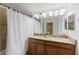 Well-lit bathroom with double sinks, granite countertops, and a shower-tub combination at 2923 Banana Palm Dr, Kissimmee, FL 34747