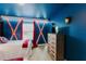 Themed bedroom with Avengers decor, including an Iron Personal mask, Captain America shields, and twin bed at 2923 Banana Palm Dr, Kissimmee, FL 34747