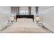 This bedroom has a bed with two bedside tables and lamps and neutral décor at 2923 Banana Palm Dr, Kissimmee, FL 34747