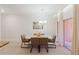 Dining area features modern table with seating for four and sliding door to lanai at 2923 Banana Palm Dr, Kissimmee, FL 34747