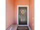 Inviting front door featuring seasonal wreath, a bench, and a 