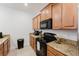 Kitchen view of oven, microwave, and granite countertops at 2923 Banana Palm Dr, Kissimmee, FL 34747