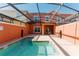 Private screened-in pool and patio with outdoor seating offer a relaxing retreat at 2923 Banana Palm Dr, Kissimmee, FL 34747