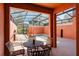 Covered outdoor patio space with dining set overlooking pool and lanai with screen enclosure at 2923 Banana Palm Dr, Kissimmee, FL 34747