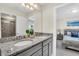 Double sink bathroom features a granite counter and access to a bedroom at 3082 Mahalo Dr, Davenport, FL 33897