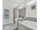 Bathroom featuring soaking tub, shower, and outdoor access to a pool at 3082 Mahalo Dr, Davenport, FL 33897
