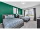 Bedroom with two beds, an accent wall, and plenty of natural light at 3082 Mahalo Dr, Davenport, FL 33897