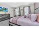 Bedroom featuring queen bed, neutral walls, window with blinds, and dresser at 3082 Mahalo Dr, Davenport, FL 33897