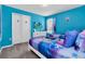 Bright, colorful bedroom with 'Frozen' themed decor and furnishings including two beds and a TV at 3082 Mahalo Dr, Davenport, FL 33897