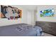 Bedroom featuring themed artwork, gray furnishings and a view to a hall bathroom at 3082 Mahalo Dr, Davenport, FL 33897